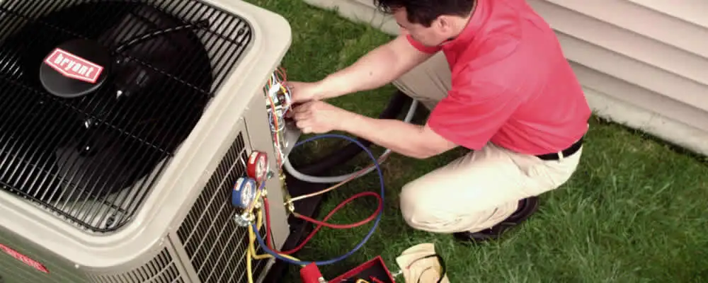 HVAC technician servicing an outdoor air conditioner unit in Raleigh, NC